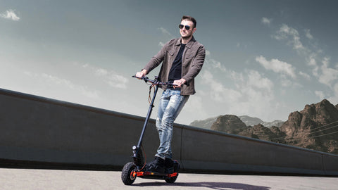 JOYOR S5-Z foldable scooter rider cruising on coastal seaside path